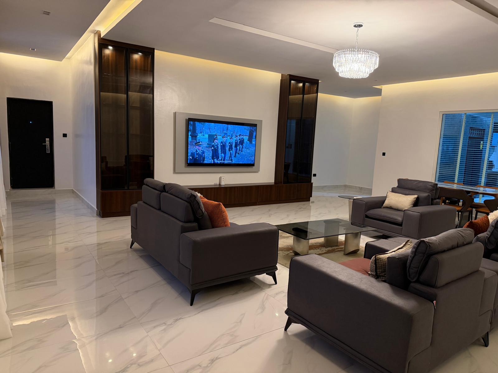 The Family Lounge — designer sofa seating, media wall and staircase